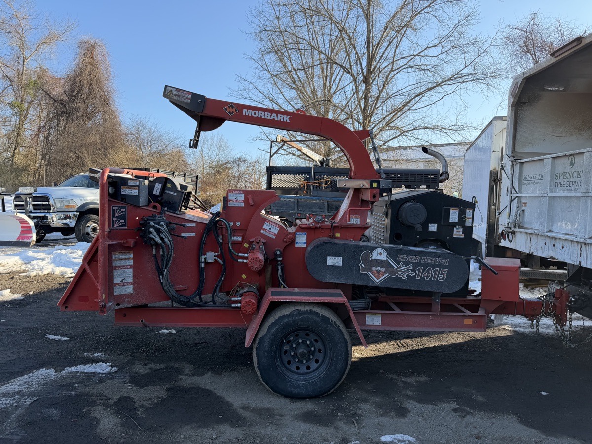 Wood chipper processing tree debris on a job site